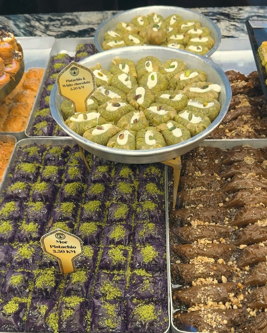 Trays of pistachio-topped baklava lined up in a Mostar sweet shop