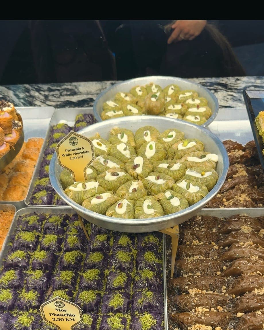 Trays of pistachio-topped baklava lined up in a Mostar sweet shop