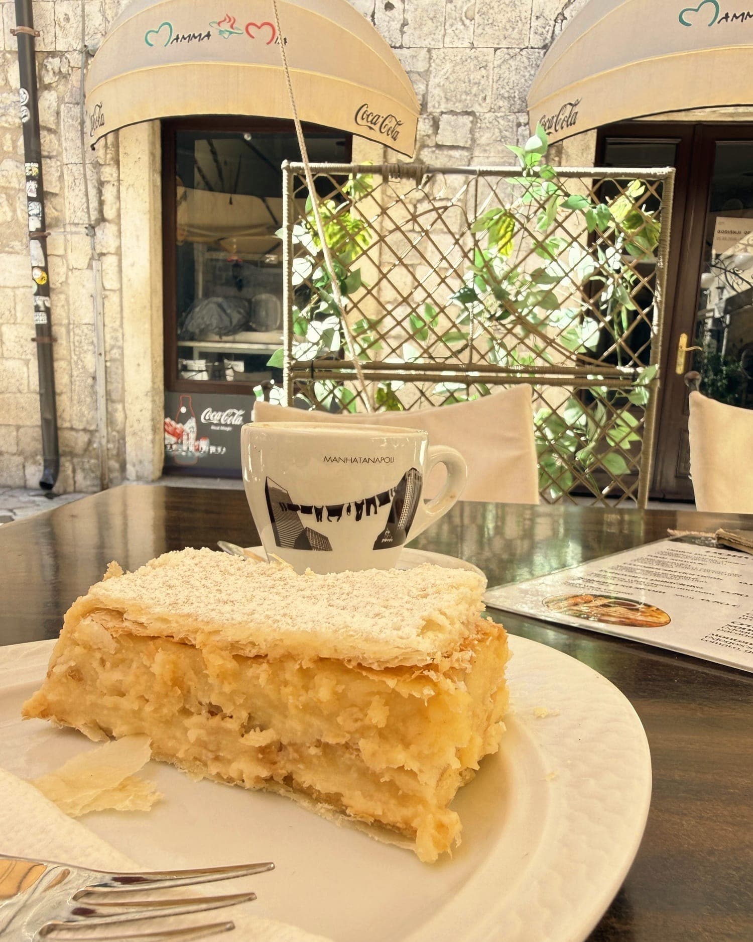 A slab of krempita on a café table in Kotor's old town