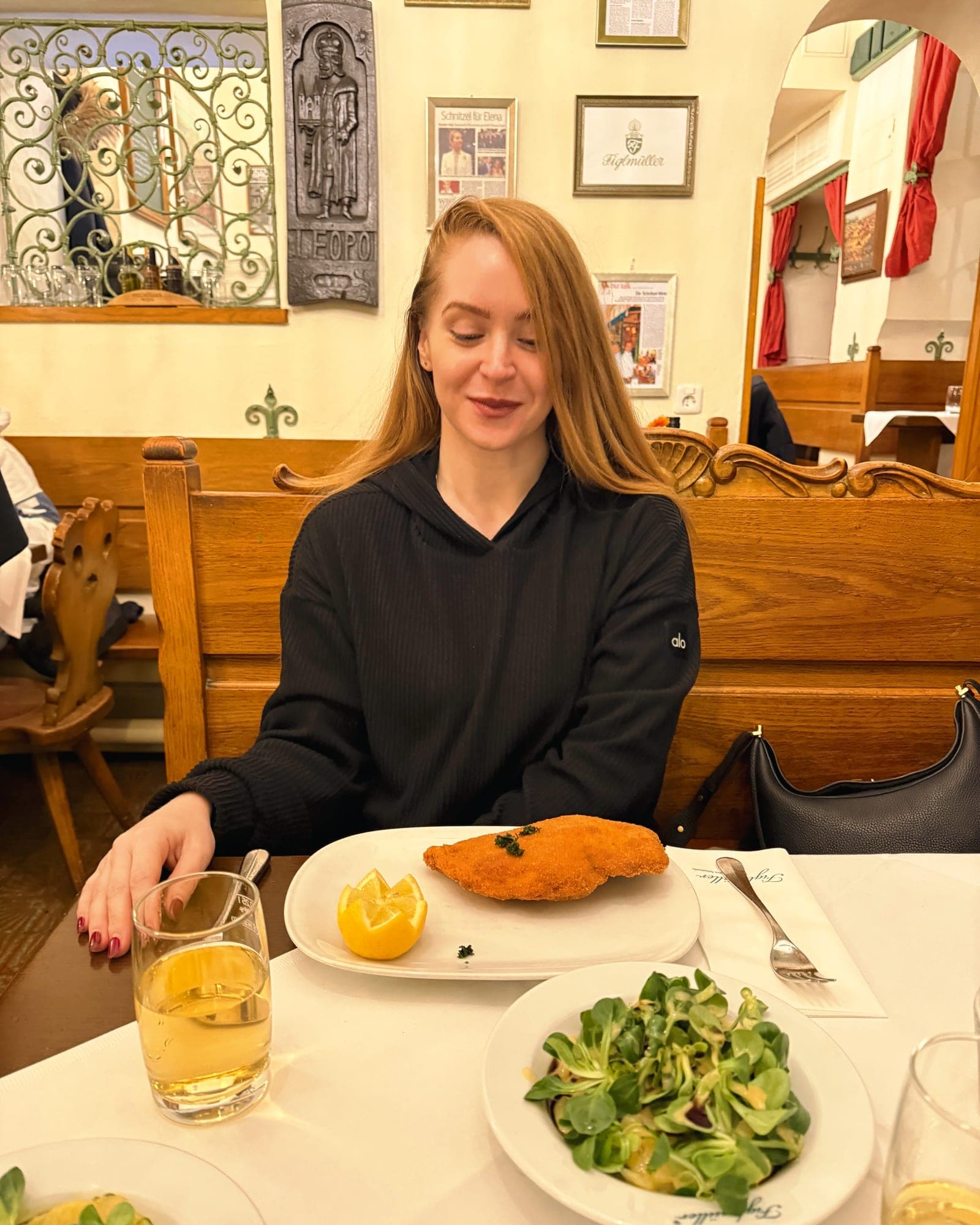 Eva at the table in Figlmüller with a schnitzel the size of the plate