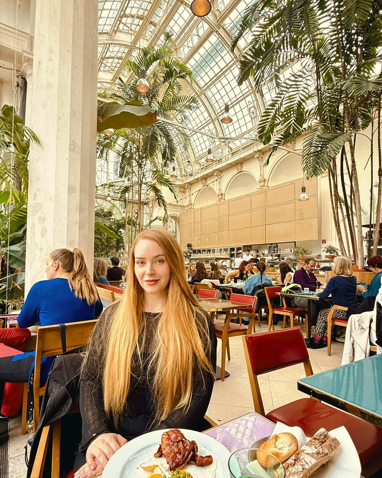 Eva at the breakfast table under the greenhouse glass