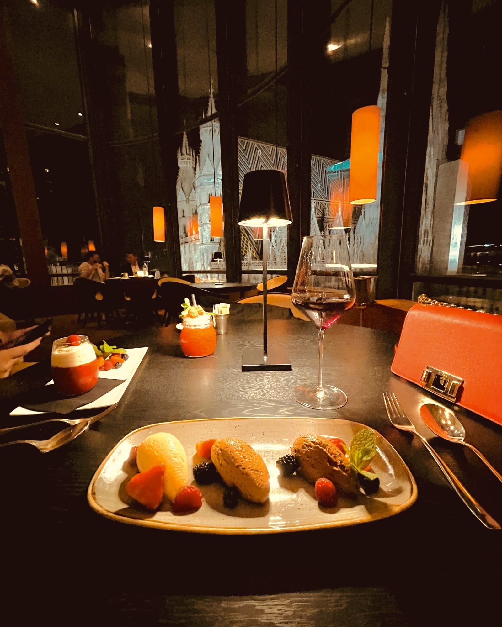 Drinks and small plates at the Onyx Bar, with the city dark outside